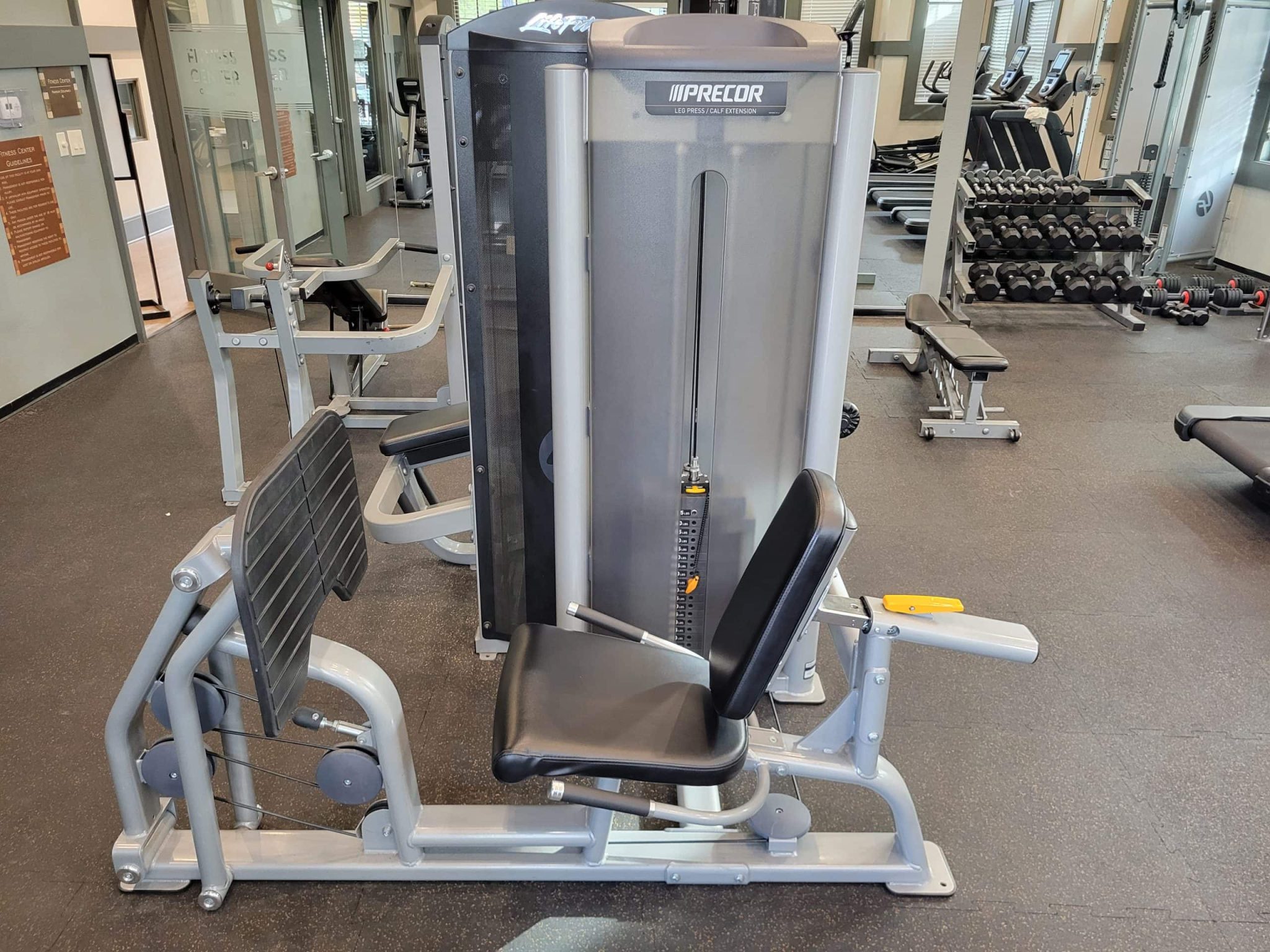 Seated leg press machine at Colorado Cardio with cardiovascular fitness equipment, strength training gear, and gym accessories in a modern wellness facility.